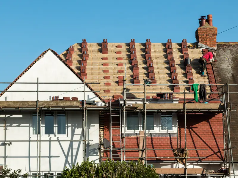 House being re-roofed behind a full scaffold