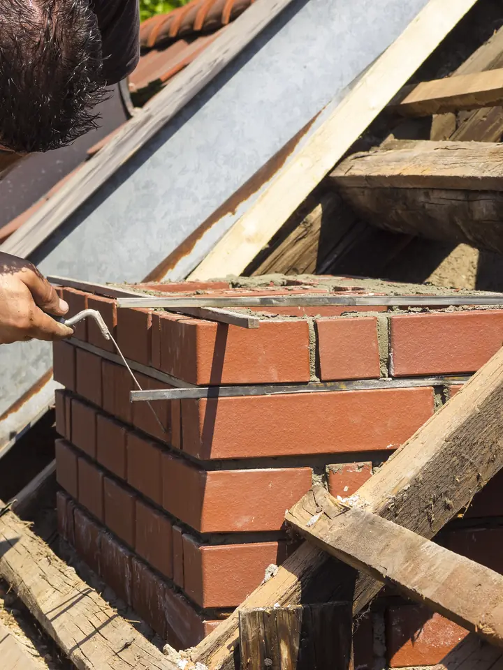 Chimney stack being rebuilt brick by brick
