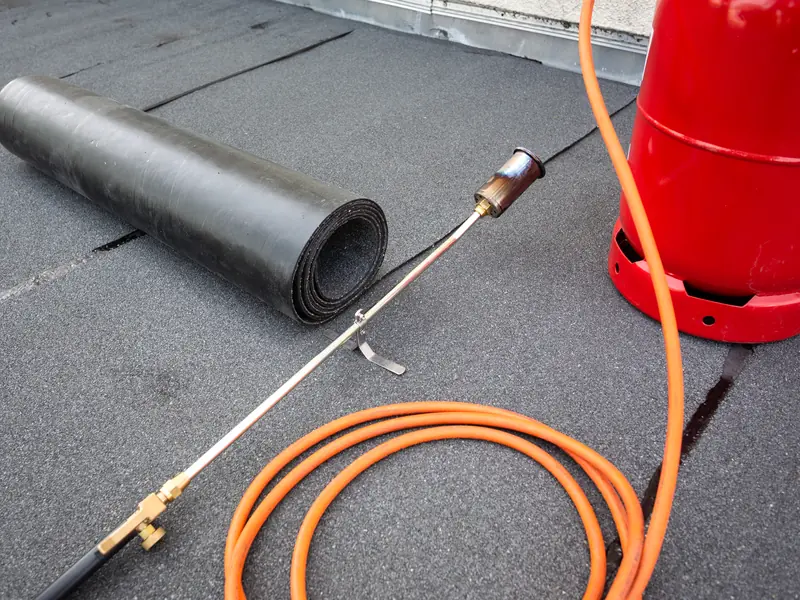 Felt roll and torch on a flat roof