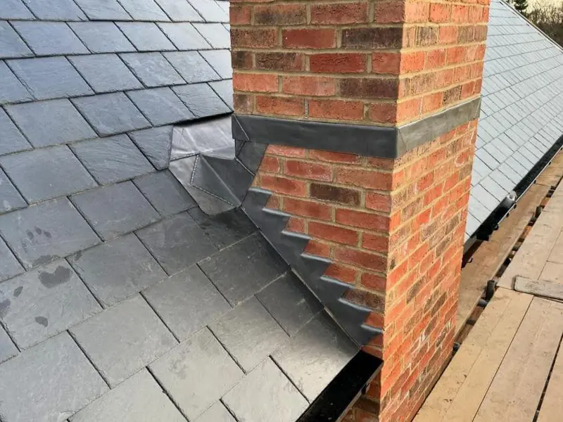 Stepped lead flashing where a slate roof meets a chimney