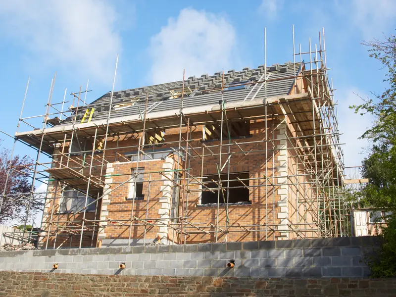 House wrapped in scaffolding during a re-roof