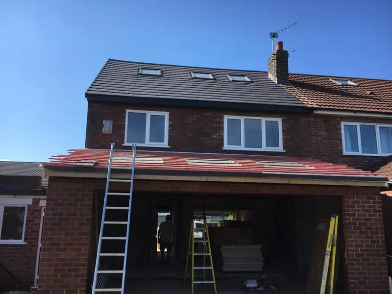 Slate roof being laid on a house extension